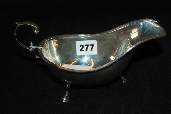 A Silver gravy boat, C-scroll handle & hoof feet, Birmingham 1932